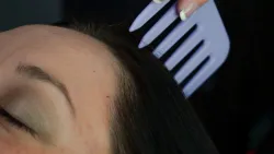 Solari guest relaxing as the comb brushes across her scalp in an autonomous sensory meridian response (ASMR) technique for relaxing